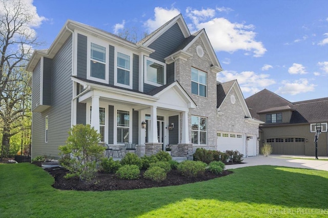 craftsman-style house featuring a porch, driveway, a front lawn, and an attached garage