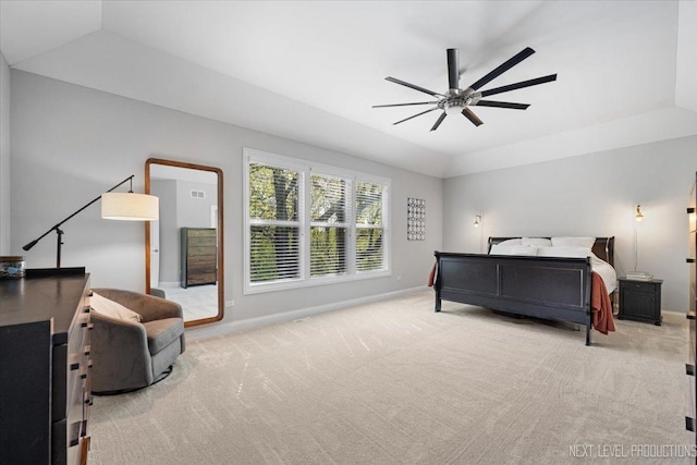 bedroom featuring baseboards, light colored carpet, a raised ceiling, and a ceiling fan