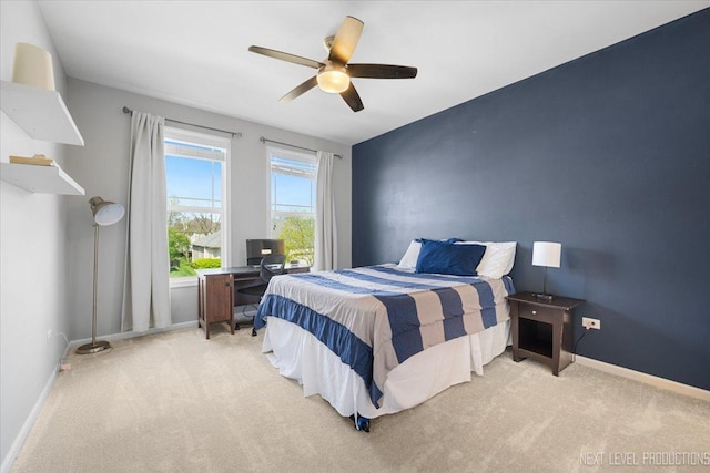 carpeted bedroom with baseboards and a ceiling fan