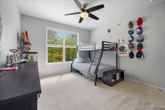 carpeted bedroom featuring baseboards and a ceiling fan