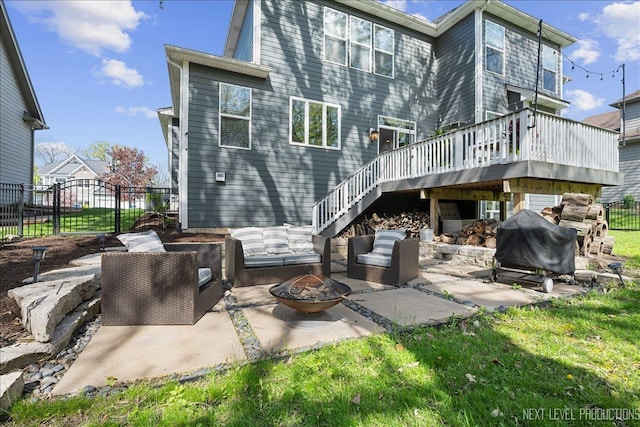 back of property with a fire pit, a patio, stairs, a wooden deck, and fence
