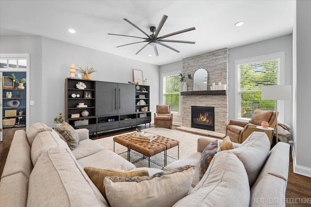 living room with healthy amount of natural light, a ceiling fan, wood finished floors, a fireplace, and recessed lighting