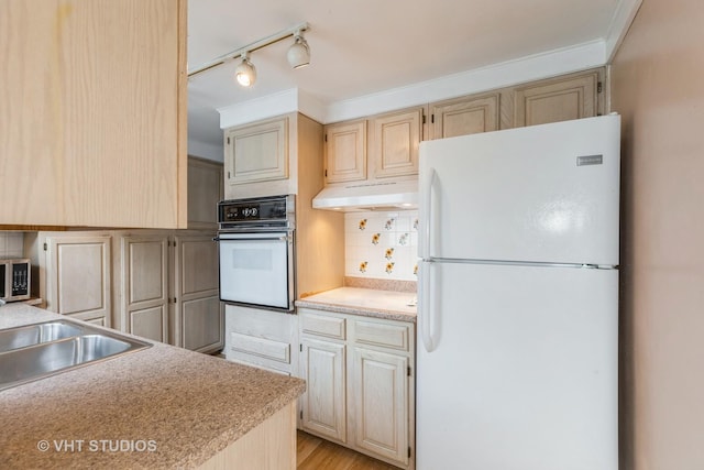 15508 Lavergne Ave, Oak Forest, IL 60452 - kitchen with white appliances, under cabinet range hood, light countertops, ornamental molding, and track lighting