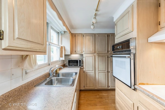 15508 Lavergne Ave, Oak Forest, IL 60452 - kitchen featuring white oven, a sink, stainless steel microwave, tasteful backsplash, and light countertops