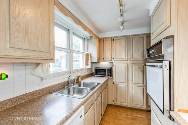 15508 Lavergne Ave, Oak Forest, IL 60452 - kitchen featuring stainless steel microwave, a sink, oven, decorative backsplash, and light wood-style floors