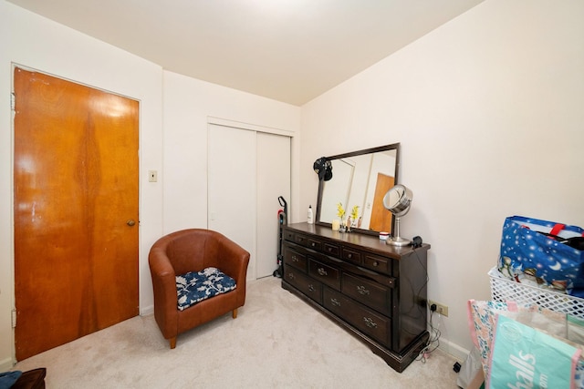 sitting room featuring light colored carpet