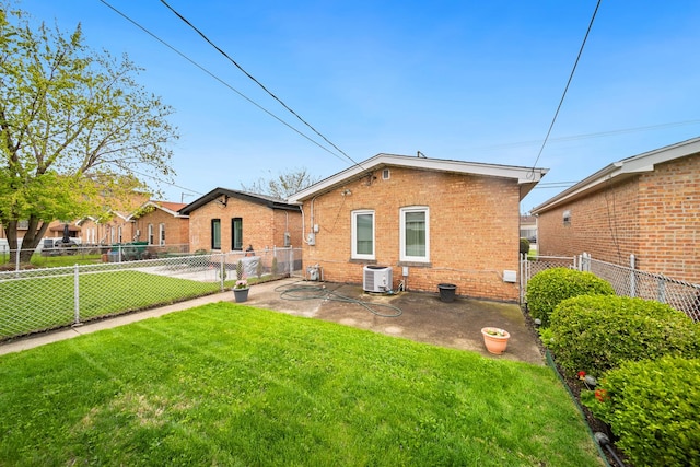 rear view of property featuring central AC unit, brick siding, and a patio area