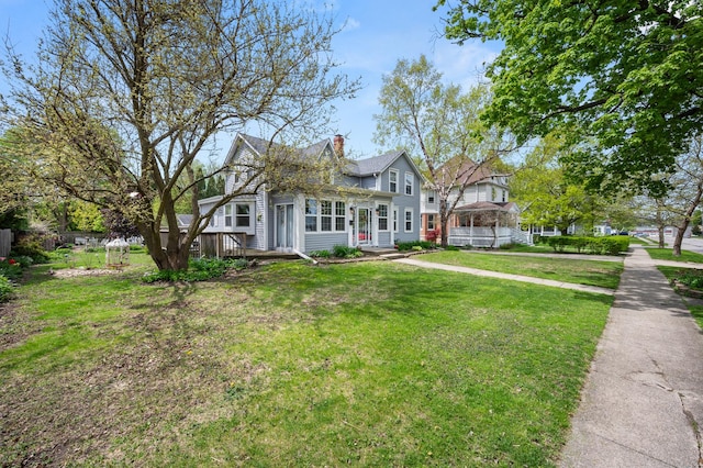 view of front of home with a front yard and a chimney