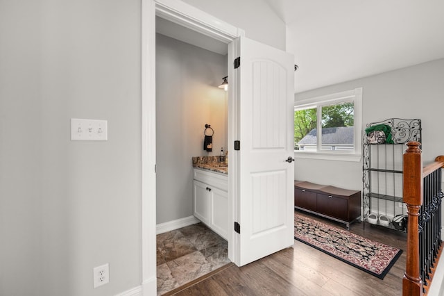 bathroom featuring wood finished floors, vanity, and baseboards
