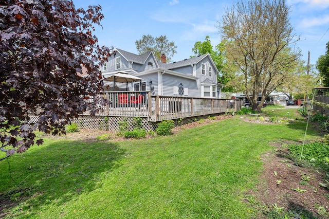 view of grassy yard featuring a deck and a gazebo