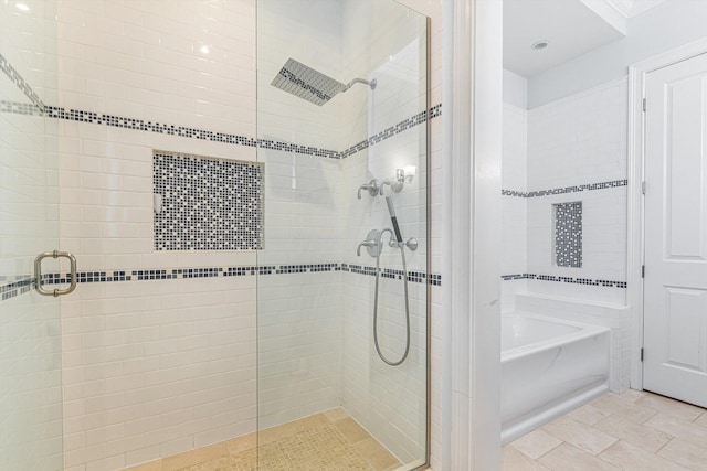 full bathroom featuring a bath and a stall shower
