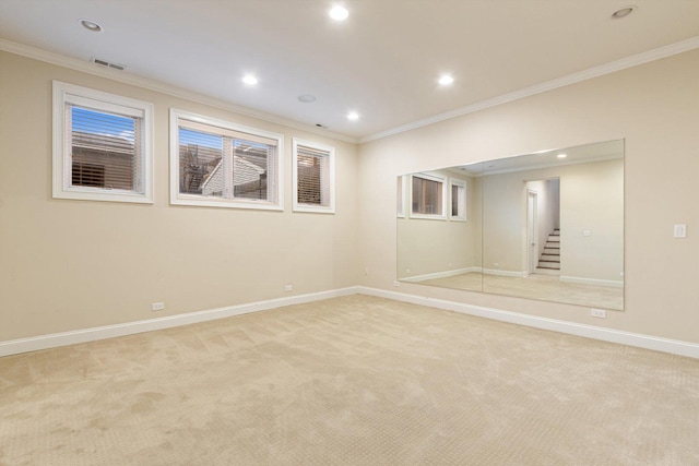 unfurnished room with baseboards, ornamental molding, and light carpet