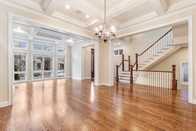 unfurnished living room featuring an inviting chandelier, wood finished floors, beamed ceiling, stairway, and coffered ceiling