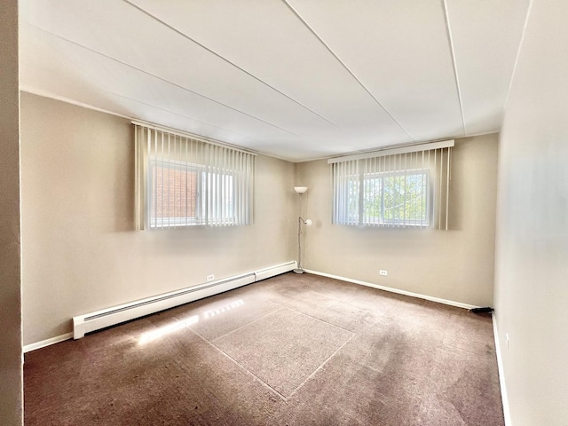 empty room featuring a baseboard radiator, baseboards, and carpet flooring