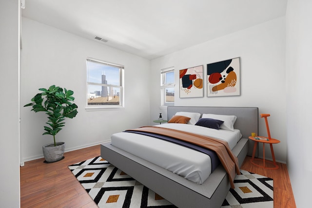 758 W 15th St Unit 3A, Chicago, IL 60607 - bedroom featuring baseboards, visible vents, and wood finished floors