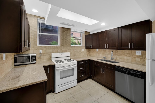 5656 S Dorchester Ave Unit B, Chicago, IL 60637 - kitchen featuring appliances with stainless steel finishes, light tile patterned floors, dark brown cabinetry, and light stone counters