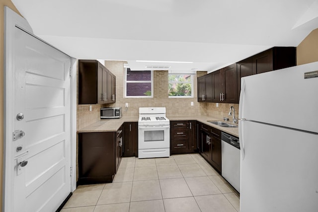 5656 S Dorchester Ave Unit B, Chicago, IL 60637 - kitchen with appliances with stainless steel finishes, decorative backsplash, light tile patterned floors, and dark brown cabinets