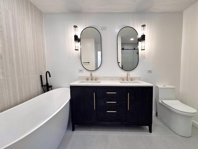 full bath with tile patterned floors, toilet, a soaking tub, and double vanity