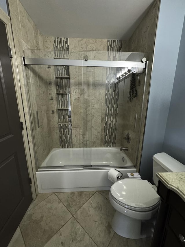 bathroom with shower / bath combination with glass door, vanity, toilet, and tile patterned flooring