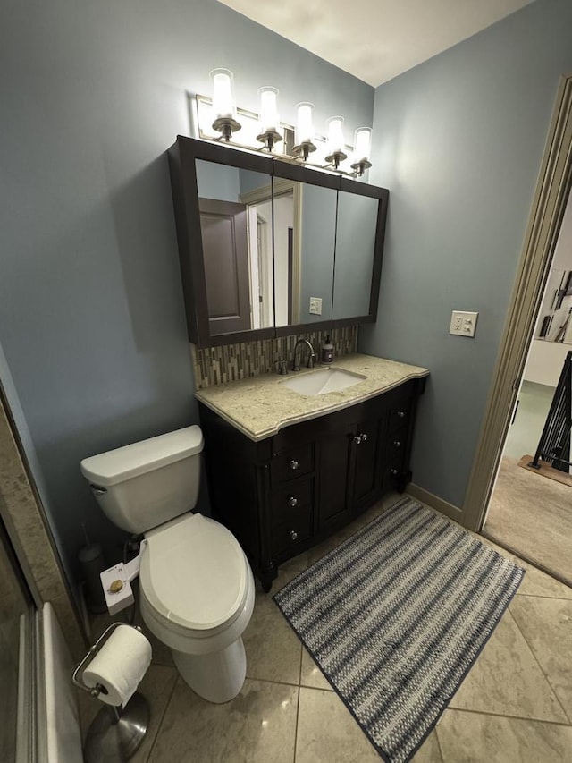 bathroom featuring toilet, vanity, and tile patterned floors