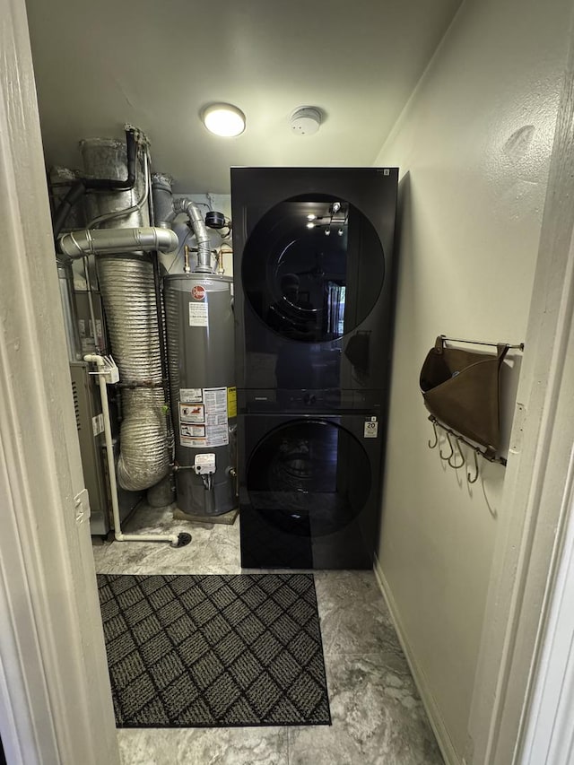 utility room featuring water heater and stacked washer and clothes dryer