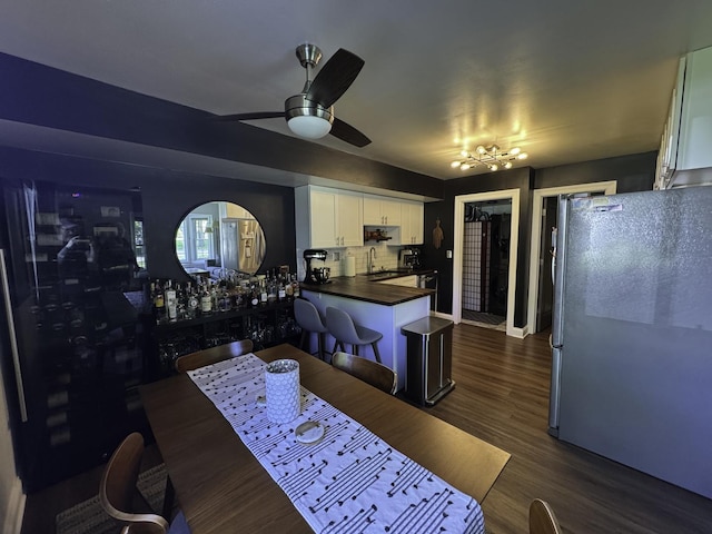 dining room with a ceiling fan and dark wood-style floors