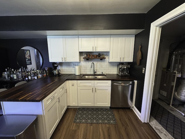 kitchen with a sink, stainless steel dishwasher, butcher block countertops, and dark wood-type flooring