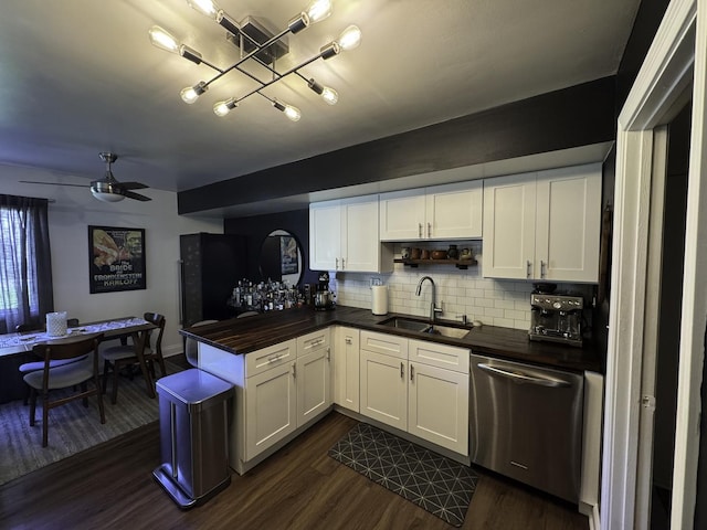 kitchen with dishwasher, a sink, decorative backsplash, and dark wood finished floors