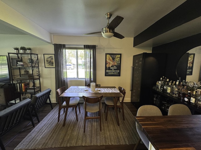 dining area featuring baseboards, ceiling fan, and wood finished floors