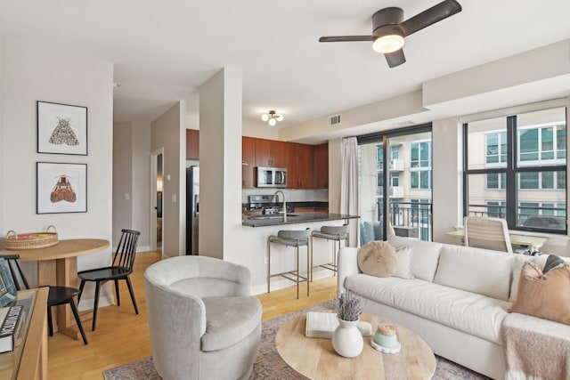 451 W Huron St Unit 1401, Chicago, IL 60654 - living room featuring light wood finished floors and a ceiling fan