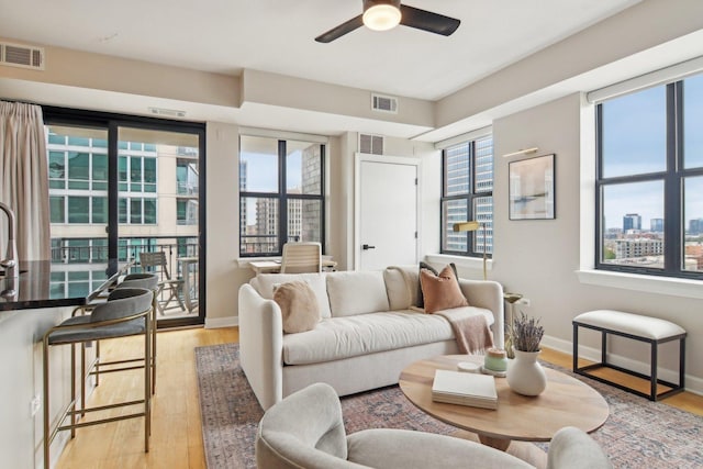 451 W Huron St Unit 1401, Chicago, IL 60654 - living room with light wood finished floors, ceiling fan, baseboards, and a view of city