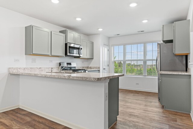 2344 Alison Ave, Pingree Grove, IL 60140 - kitchen with stainless steel appliances, gray cabinets, baseboards, dark wood finished floors, and a peninsula