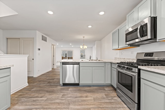 2344 Alison Ave, Pingree Grove, IL 60140 - kitchen with stainless steel appliances, a peninsula, a sink, light wood-type flooring, and recessed lighting