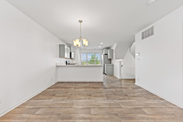 2344 Alison Ave, Pingree Grove, IL 60140 - kitchen with a chandelier, light wood-type flooring, a peninsula, hanging light fixtures, and gray cabinetry