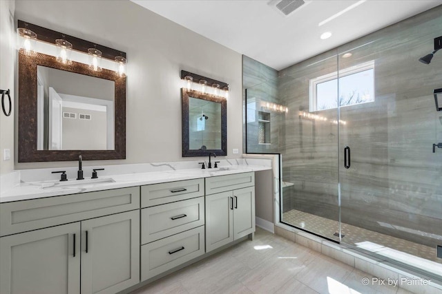 full bath featuring a shower stall and double vanity