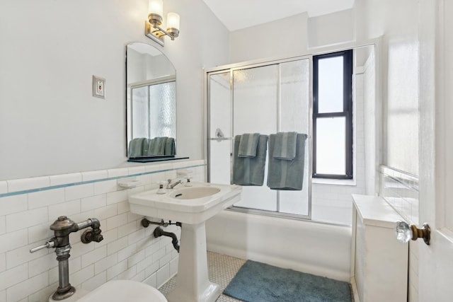 1755 E 55th St Unit 1204, Chicago, IL 60615 - full bathroom featuring tile walls, plenty of natural light, combined bath / shower with glass door, and wainscoting