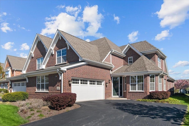 1147 Morgan St, Northbrook, IL 60062 - view of front of house featuring asphalt driveway, brick siding, and a shingled roof