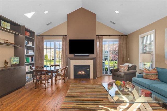 1147 Morgan St, Northbrook, IL 60062 - living room with wood finished floors, a glass covered fireplace, high vaulted ceiling, plenty of natural light, and recessed lighting