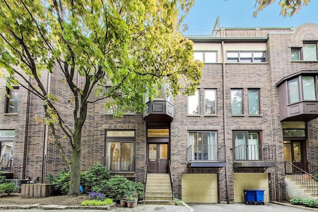 215 W Concord Ln, Chicago, IL 60614 - multi unit property with brick siding, a garage, and driveway