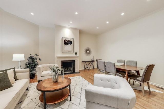 215 W Concord Ln, Chicago, IL 60614 - living room with crown molding, light wood-style floors, recessed lighting, a fireplace with flush hearth, and baseboards
