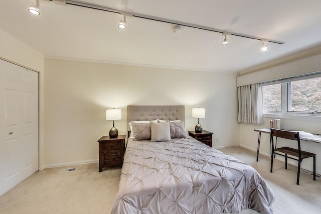 215 W Concord Ln, Chicago, IL 60614 - bedroom featuring track lighting, light colored carpet, ornamental molding, and baseboards