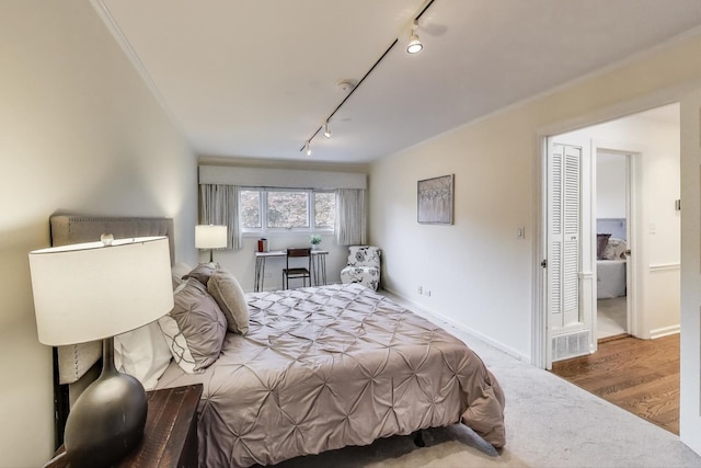 215 W Concord Ln, Chicago, IL 60614 - bedroom featuring track lighting, wood finished floors, and baseboards