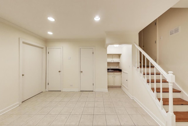 215 W Concord Ln, Chicago, IL 60614 - basement featuring recessed lighting, stairs, a sink, ornamental molding, and baseboards