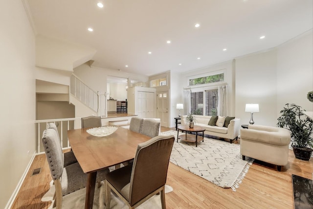 215 W Concord Ln, Chicago, IL 60614 - dining space featuring light wood-style flooring, stairs, recessed lighting, baseboards, and crown molding
