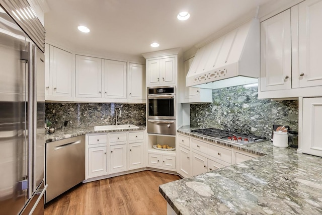 215 W Concord Ln, Chicago, IL 60614 - kitchen featuring stainless steel appliances, a sink, a warming drawer, premium range hood, and decorative backsplash