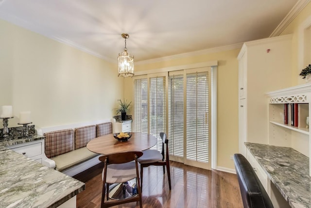 215 W Concord Ln, Chicago, IL 60614 - dining space with dark wood finished floors, crown molding, breakfast area, a chandelier, and baseboards