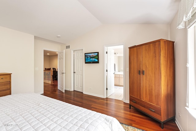1254 Townes Cir, Aurora, IL 60502 - bedroom featuring wood finished floors, vaulted ceiling, and ensuite bathroom