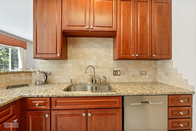 kitchen featuring stainless steel dishwasher, a sink, light stone counters, and tasteful backsplash