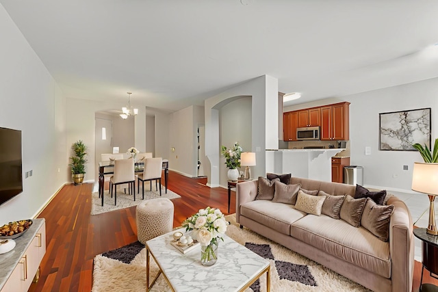 1254 Townes Cir, Aurora, IL 60502 - living area with arched walkways, dark wood-type flooring, and a chandelier