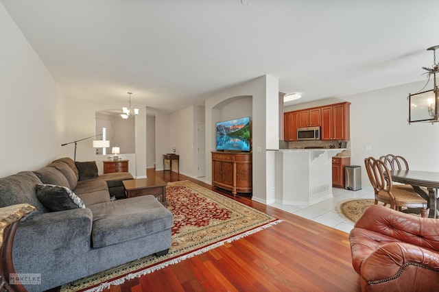 living area with a chandelier and light wood-style flooring
